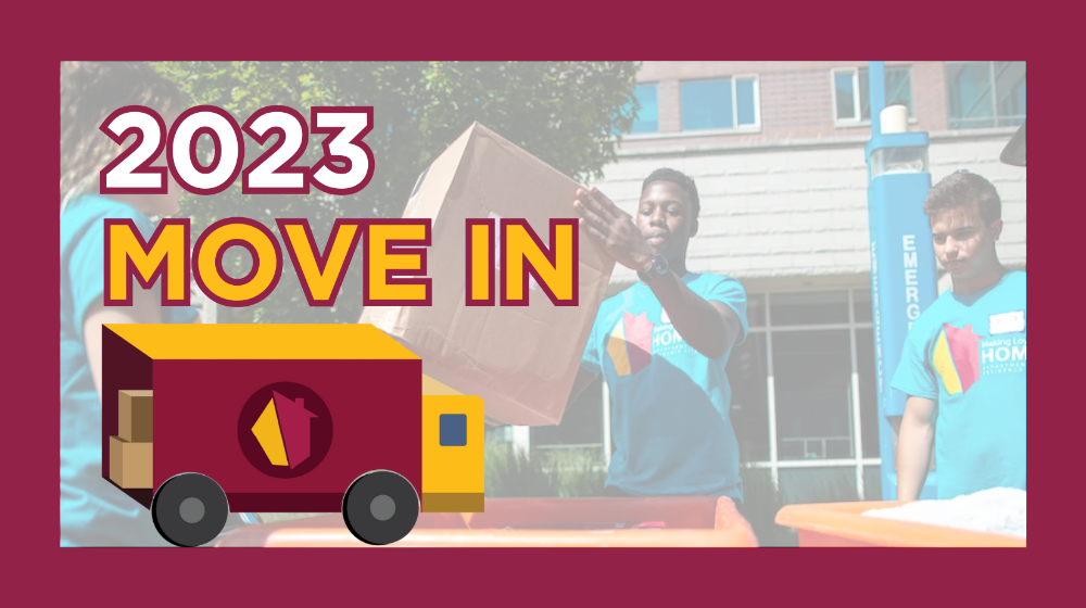 2023 Move In with two male students moving boxes